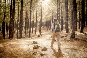 young woman hiking in a pine wood