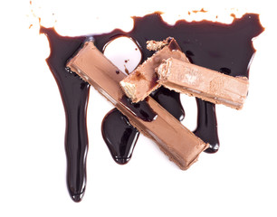 Melted chocolate dripping on white background