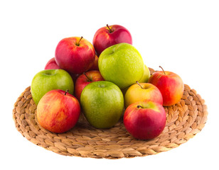 Fresh red and green apples in a wooden basket, isolated