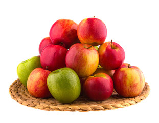 Red and green apples in a wooden basket, isolated