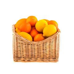 Oranges and lemons in a wooden basket.