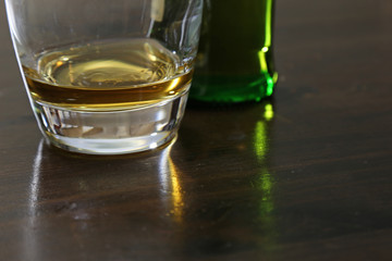 A small amount of scotch whisky sitting on a table..