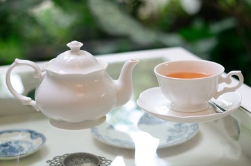 a white cup of tea on classic table
