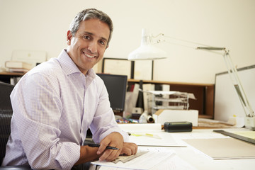 Male Architect Working At Desk In Office
