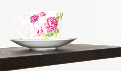 cup and saucer on a wooden surface