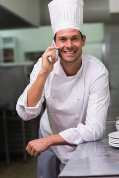 Smiling chef talking on the phone
