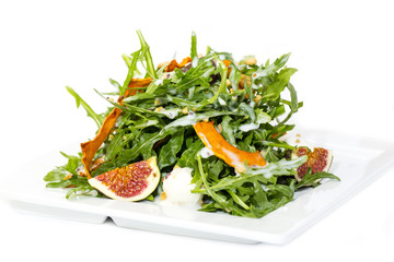 salad of arugula figs and cheese on white background