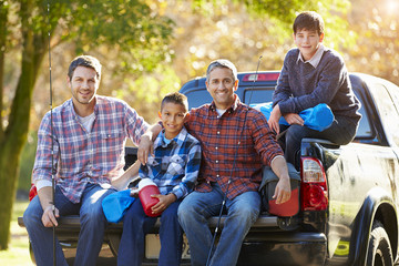 Fathers With Sons Sitting In Truck On Camping Holiday