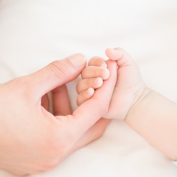 Mother Holding Baby Sons Hand