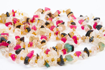 beads of different stones on a white background