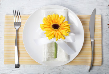 yellow gerbera with table set