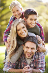 Portrait Of Family Lying On Grass In Countryside