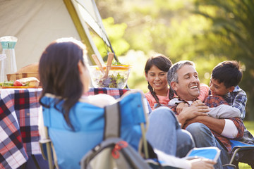 Family Enjoying Camping Holiday In Countryside