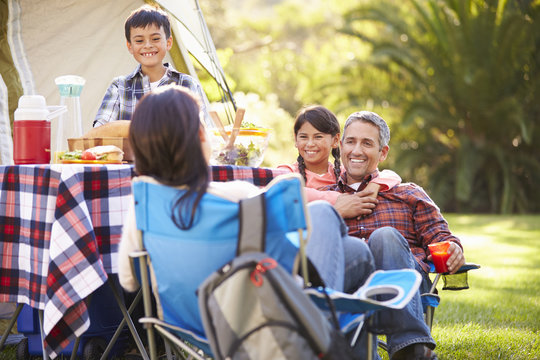 Family Enjoying Camping Holiday In Countryside