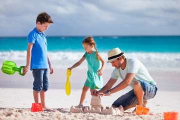 Father with kids at beach