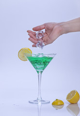 Dropping ice into cocktail.