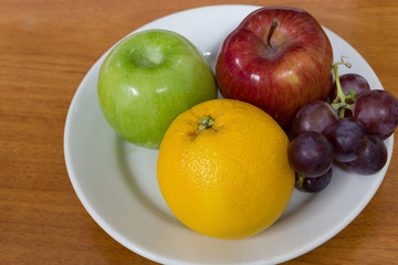 Healthy fruits like grapes, oranges and apples