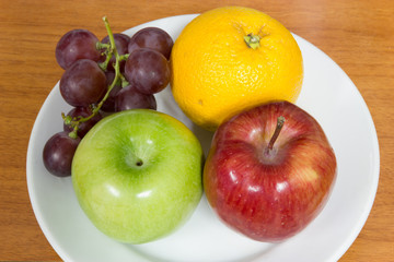 Healthy fruits like grapes, oranges and apples