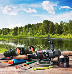 fishing tackle on a pontoon on the background of the lake
