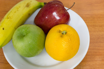 Healthy fruits like banana, oranges and apples