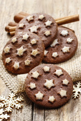 Obraz na płótnie Canvas Round chocolate cookies decorated with icing stars