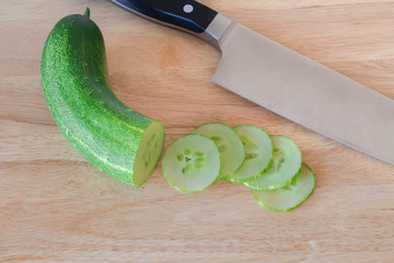 cucumber slices on wooden background