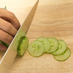 cucumber slices on wooden background