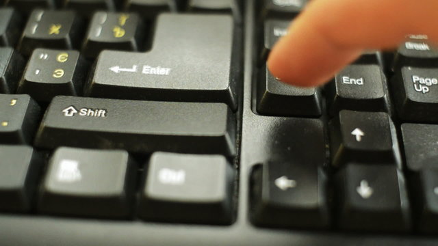finger presses the delete key on your keyboard