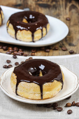 Delicious donut with chocolate on wooden table