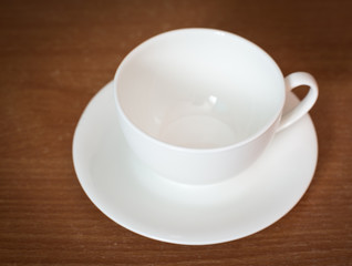 Empty coffee cup on old wooden table. Selective focus.