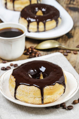 Delicious donut with chocolate on wooden table