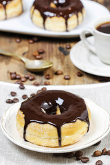 Delicious donut with chocolate on wooden table