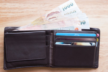 Brown leather wallet with money