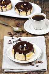 Delicious donut with chocolate on wooden table