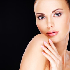 Naklejka premium Beautiful face of the adult woman with fresh skin