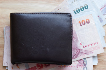 Brown leather wallet with money