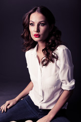 Lovely woman in white blouse and blue jeans 