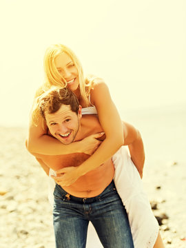 happy family couple in love hugging and laughing on the beach
