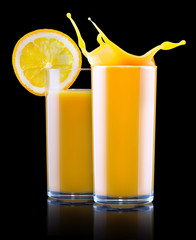 Fresh orange juice in glass with splash
