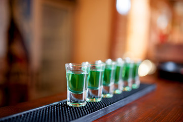 alcoholic shots of different drinks at a party in a nightclub