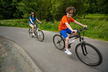 Healthy lifestyle - teenage girl and boy biking