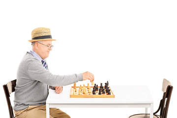 Senile old man playing a game of chess alone