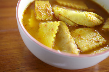 yellow fish curry and coconut in sun light