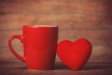 Heart shape and red cup of coffee.
