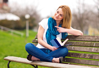 attractive woman on the bench with book