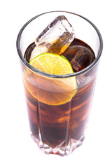 Cola in tall glass with ice cubes and lime over white 