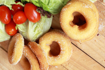 donut and sugar - fresh vegetable salad.