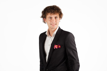 Portrait Of A young curly Man standing On Grey Background