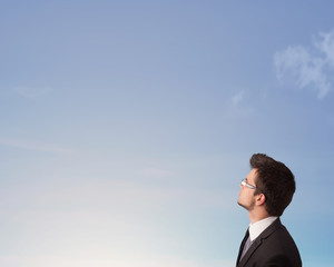 Handsome man looking at the blue sky copyspace