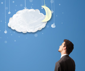 Businessman looking at cartoon night clouds with moon